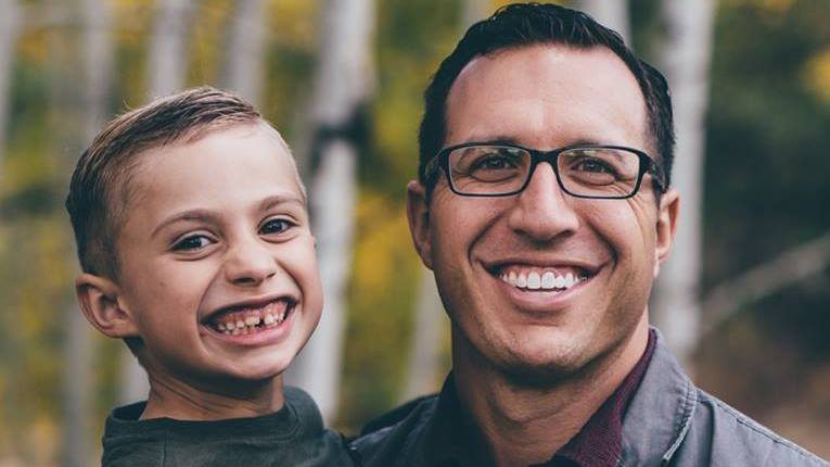 Father and son smiling