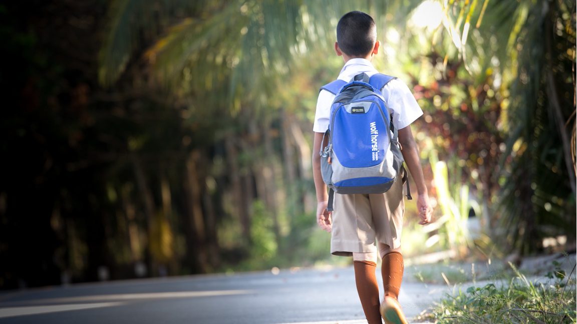 student walking away along sideroad