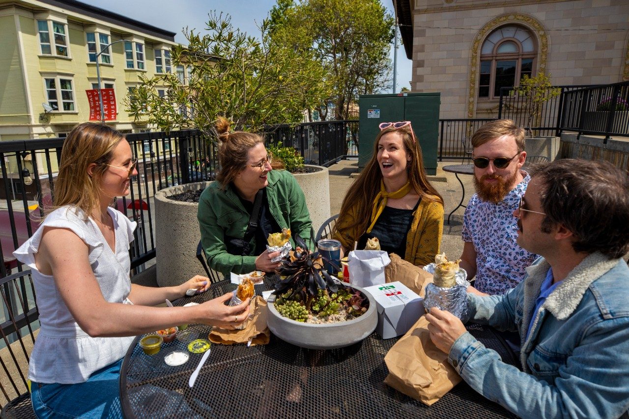 Group of friends eating around table